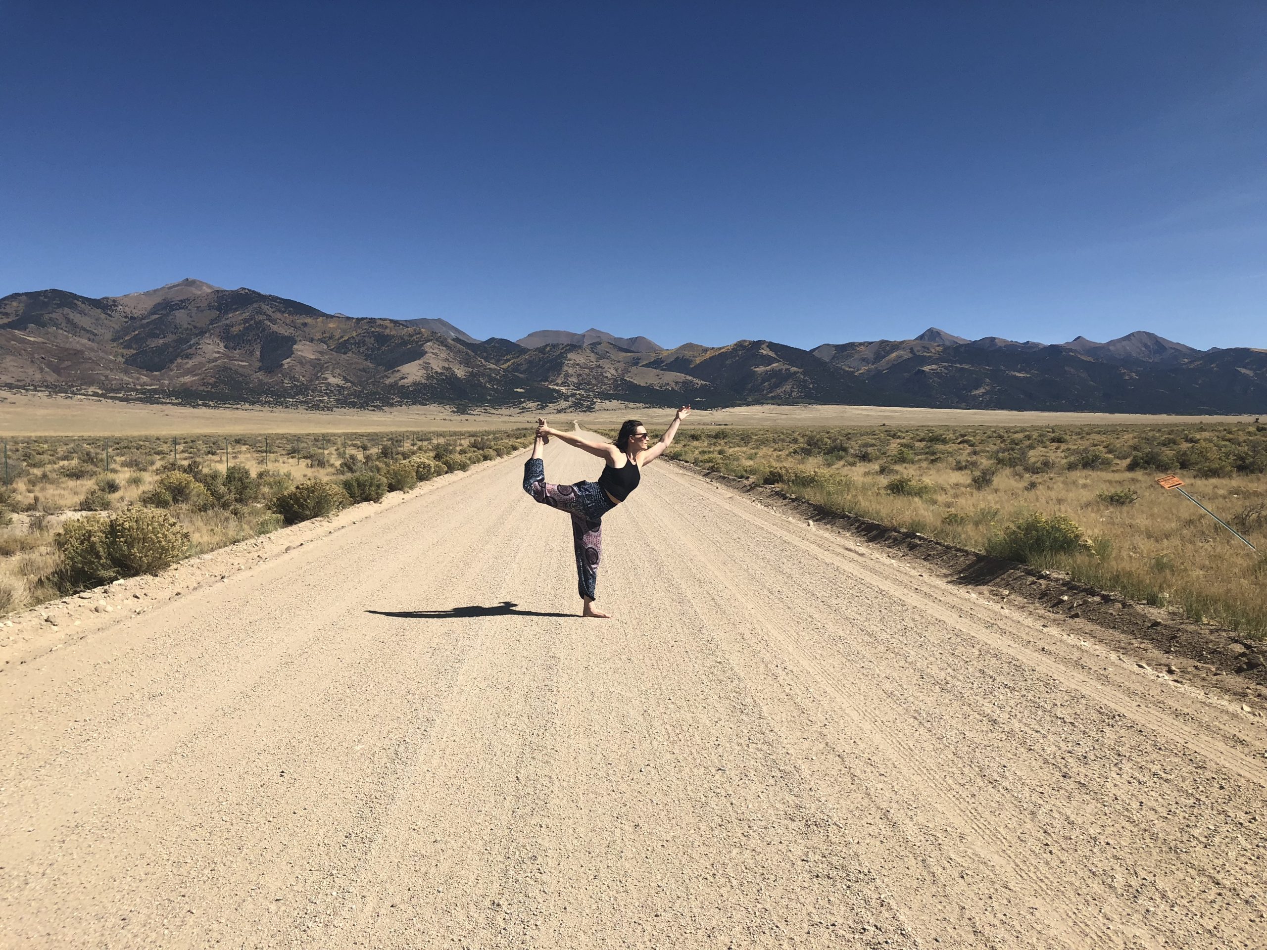 woman doing a yoga pose on a landscape